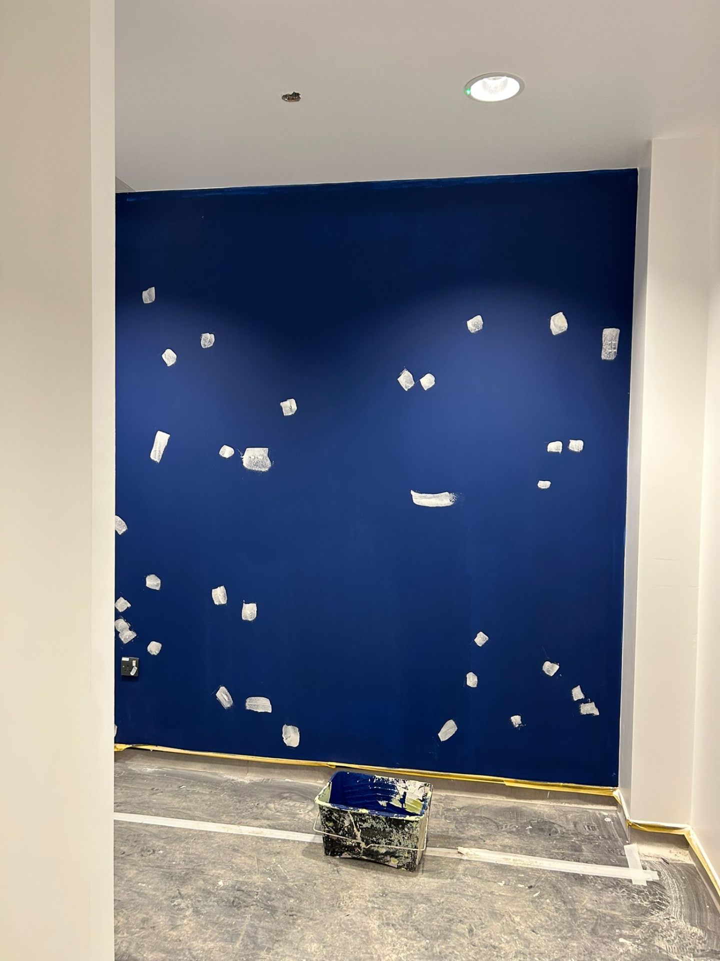 Cobalt blue accent wall, second-coat prep with filler spotting, by Bendrick Painting & Decorating