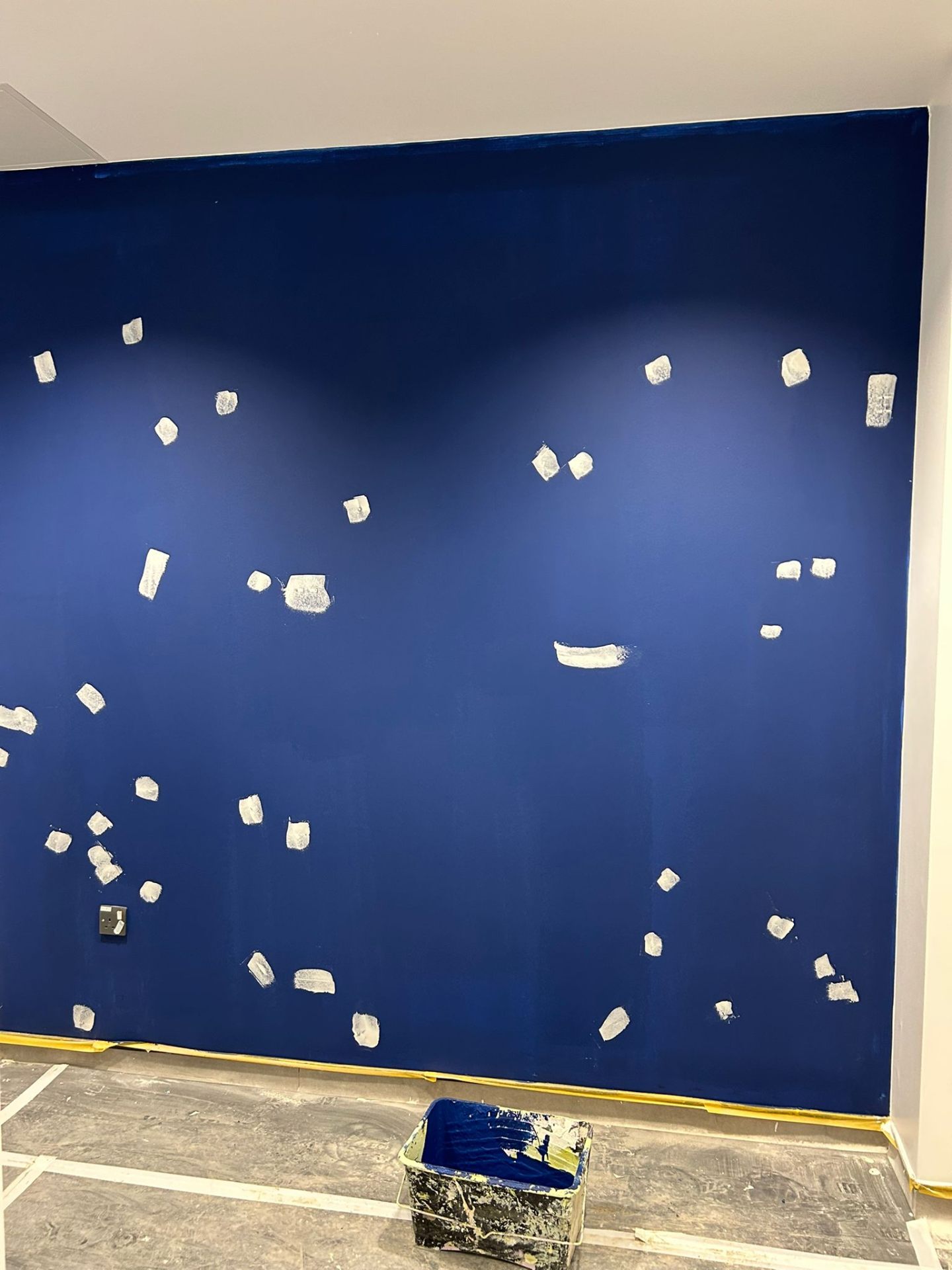 Cobalt blue accent wall mid second-coat preparation